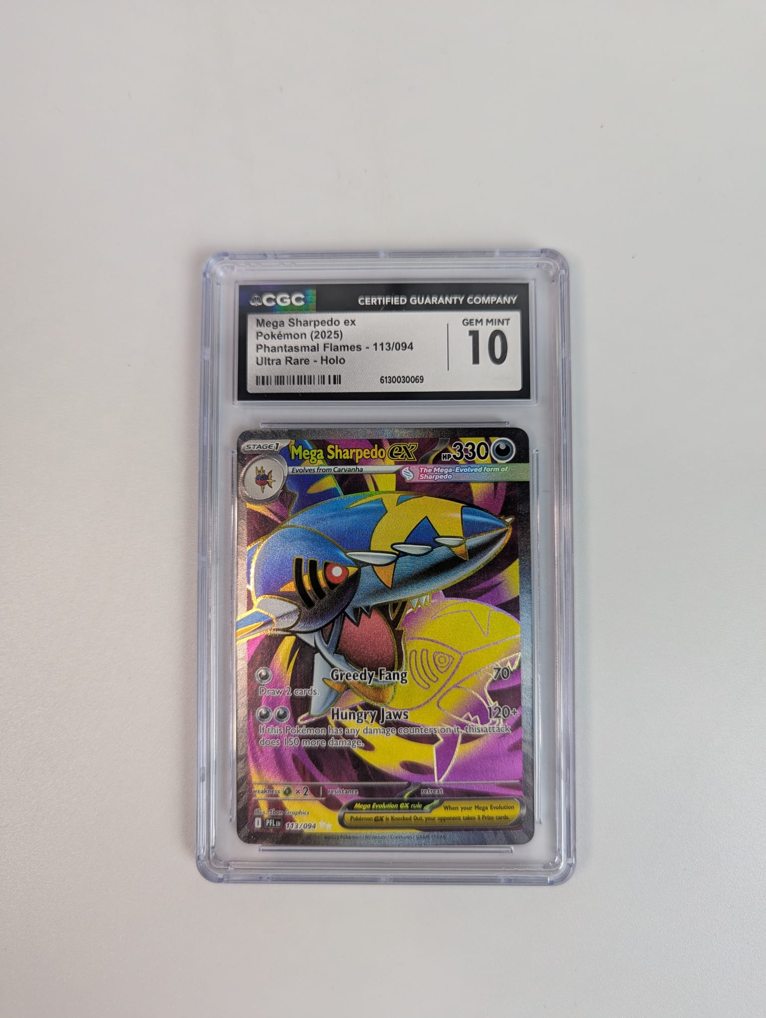 Pokémon trading card in protective case with CGC 10 grading label on a light gray background